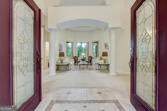 tiled foyer featuring decorative columns