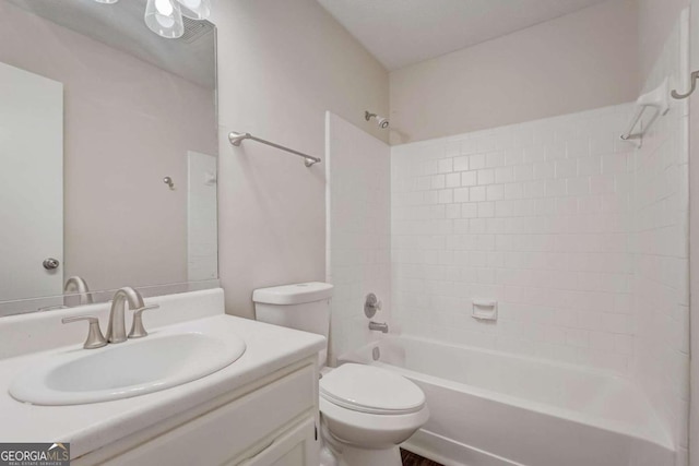 full bathroom featuring toilet, vanity with extensive cabinet space, and tiled shower / bath combo