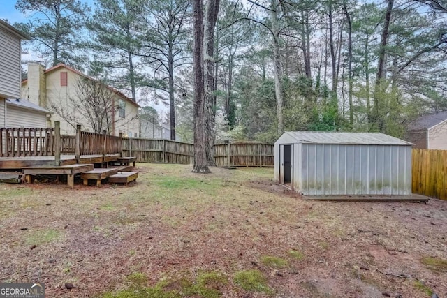 view of yard featuring a deck and a shed