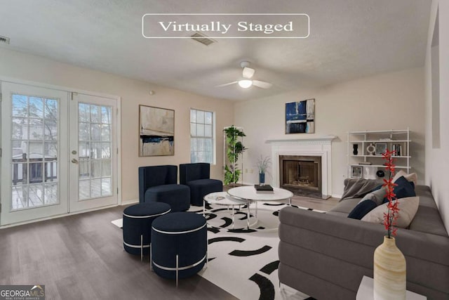 living room featuring ceiling fan, dark hardwood / wood-style floors, and french doors