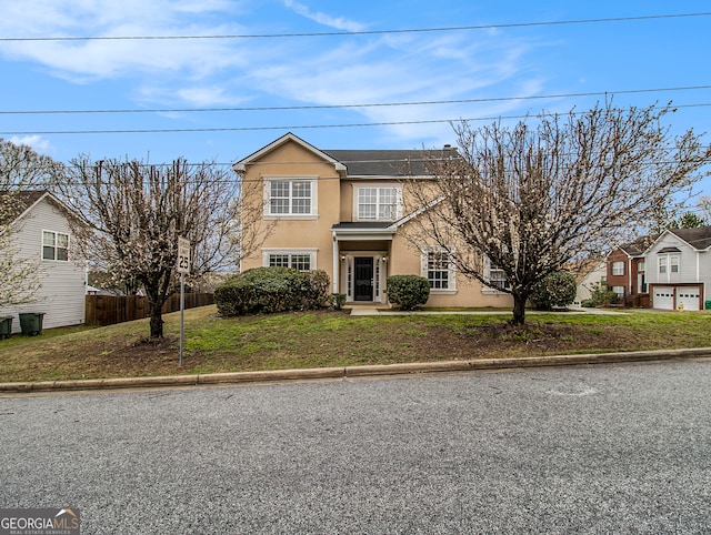 view of front property with a front lawn, a garage, and solar panels