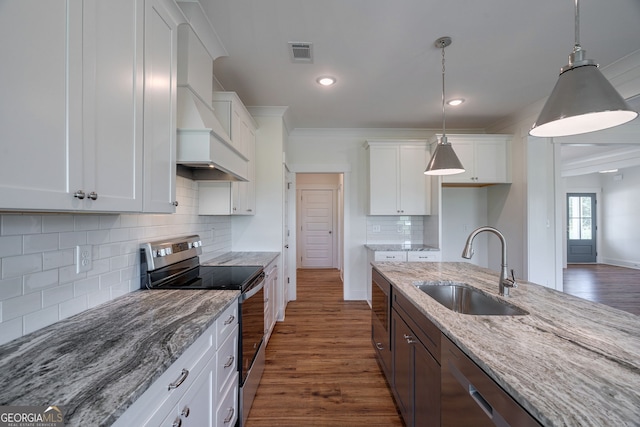 kitchen featuring white cabinets, appliances with stainless steel finishes, and premium range hood