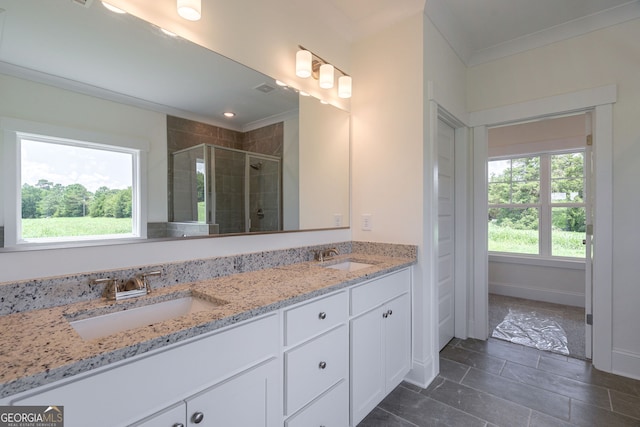 bathroom with walk in shower, vanity, and crown molding