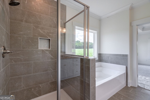 bathroom featuring plus walk in shower, crown molding, and tile patterned floors