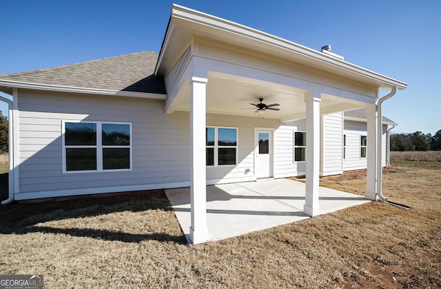 rear view of property with ceiling fan and a patio