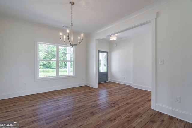 unfurnished room with a chandelier, dark hardwood / wood-style floors, and ornamental molding