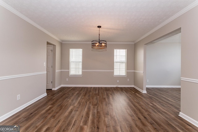 spare room featuring crown molding, dark hardwood / wood-style floors, and a textured ceiling