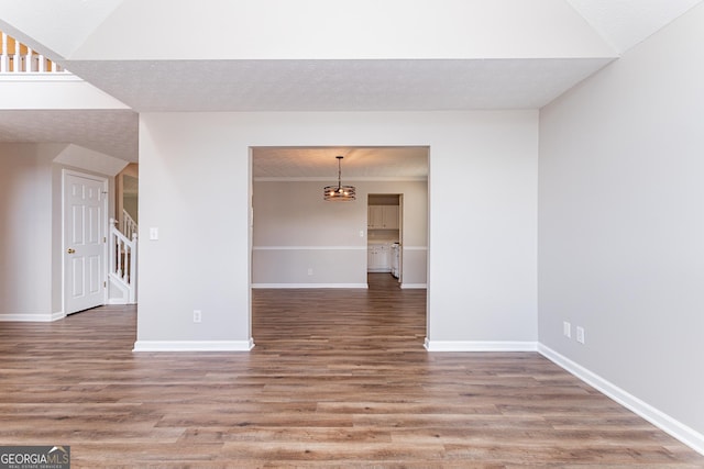 empty room with hardwood / wood-style floors and a textured ceiling