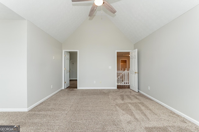 unfurnished bedroom featuring ceiling fan, light colored carpet, and high vaulted ceiling