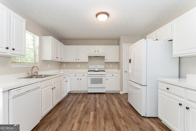 kitchen featuring white cabinetry, sink, dark hardwood / wood-style flooring, white appliances, and a textured ceiling