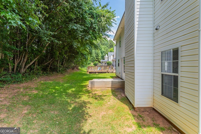 view of yard featuring a wooden deck