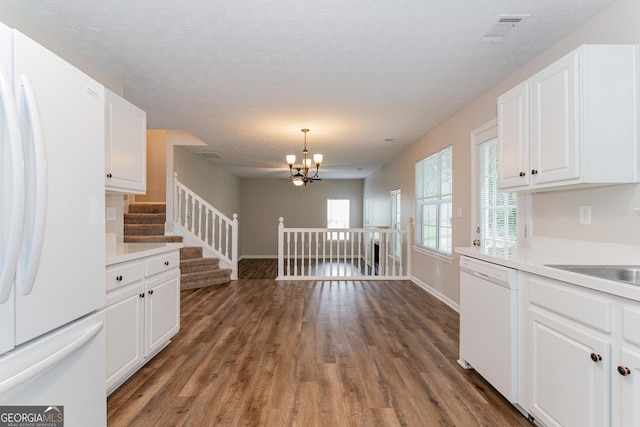 kitchen with decorative light fixtures, a chandelier, dark hardwood / wood-style floors, white appliances, and white cabinets