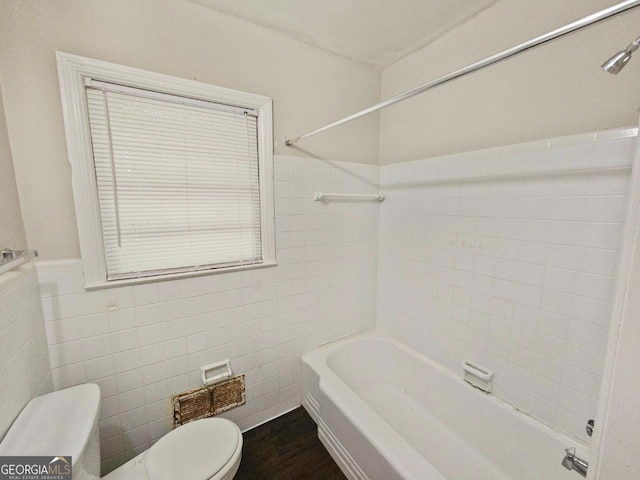 bathroom featuring toilet, tile walls, hardwood / wood-style flooring, and shower / bath combination