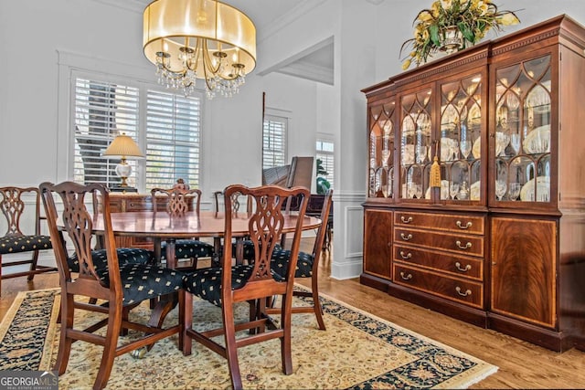 dining space featuring an inviting chandelier and light hardwood / wood-style flooring