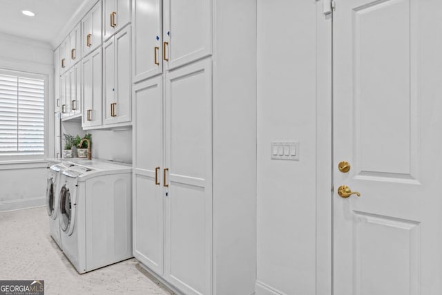 laundry room featuring cabinets and washing machine and clothes dryer