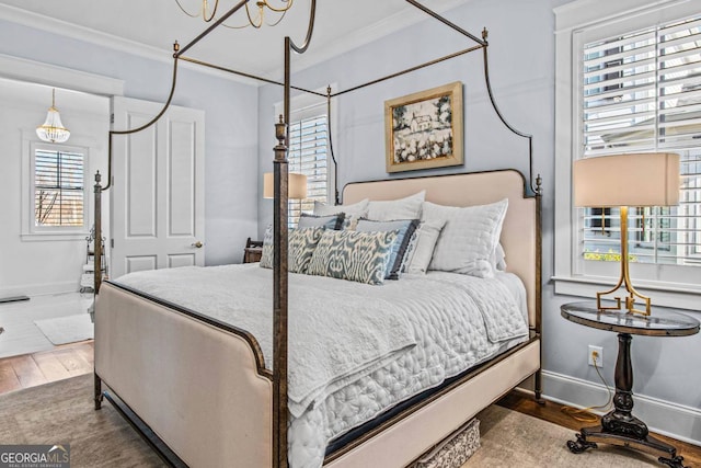 bedroom featuring ornamental molding, dark hardwood / wood-style floors, and multiple windows