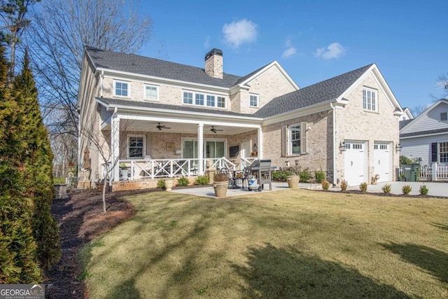 back of property featuring a patio area, a lawn, ceiling fan, and a garage