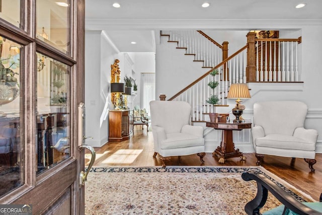 living room with crown molding and hardwood / wood-style flooring