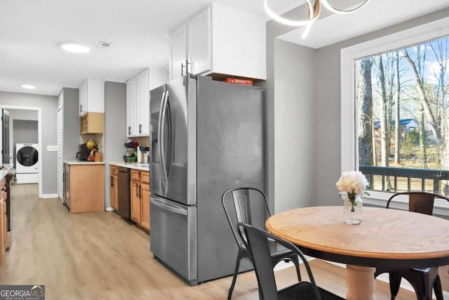 kitchen with white cabinetry, stainless steel fridge with ice dispenser, light hardwood / wood-style flooring, dishwasher, and washer / clothes dryer