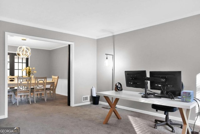 carpeted home office with a chandelier and crown molding