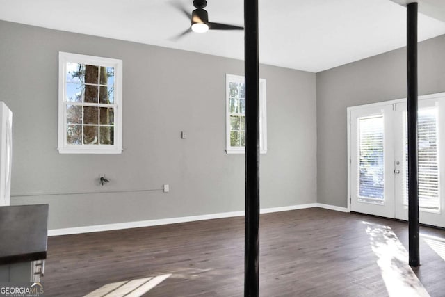 unfurnished bedroom with ceiling fan, french doors, dark wood-type flooring, and multiple windows