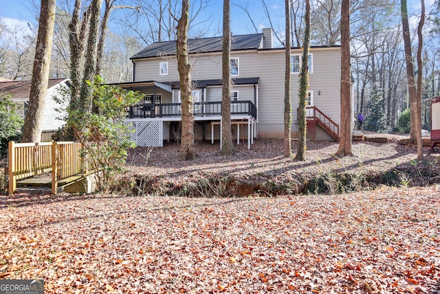 rear view of house with a wooden deck