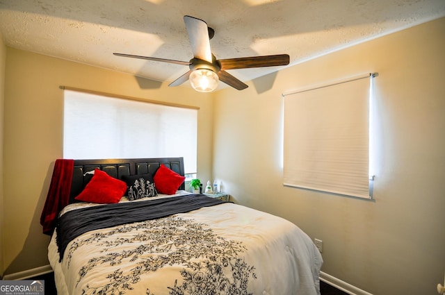 bedroom featuring a textured ceiling and ceiling fan