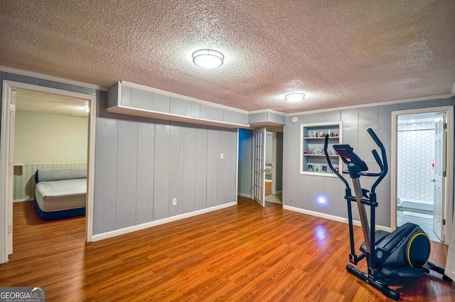 workout area with a textured ceiling and hardwood / wood-style floors