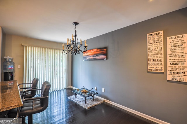 office area with dark hardwood / wood-style floors and a chandelier