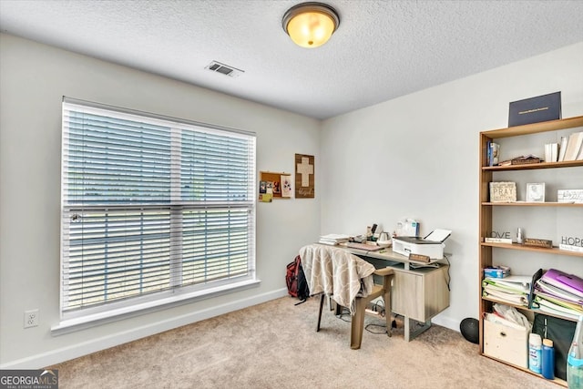 office area with light colored carpet and a textured ceiling