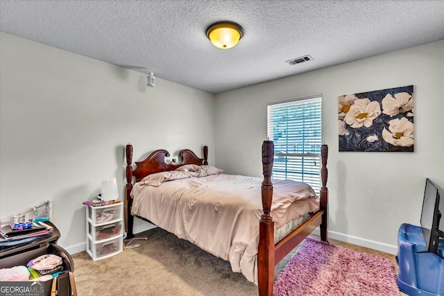 carpeted bedroom featuring a textured ceiling