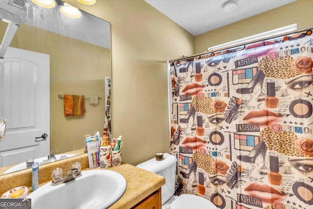 bathroom with large vanity and toilet