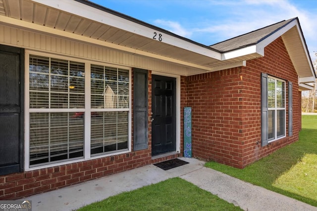 doorway to property featuring a yard