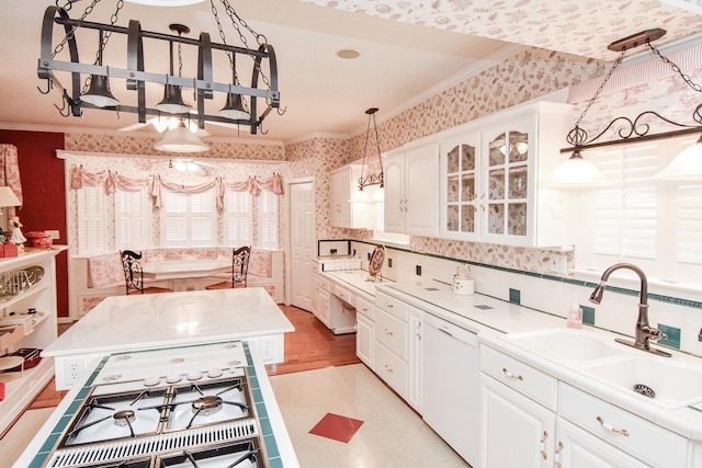 kitchen featuring light wood-type flooring, sink, white dishwasher, crown molding, and white cabinets