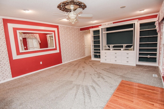 interior space with crown molding, ceiling fan, light colored carpet, and a textured ceiling