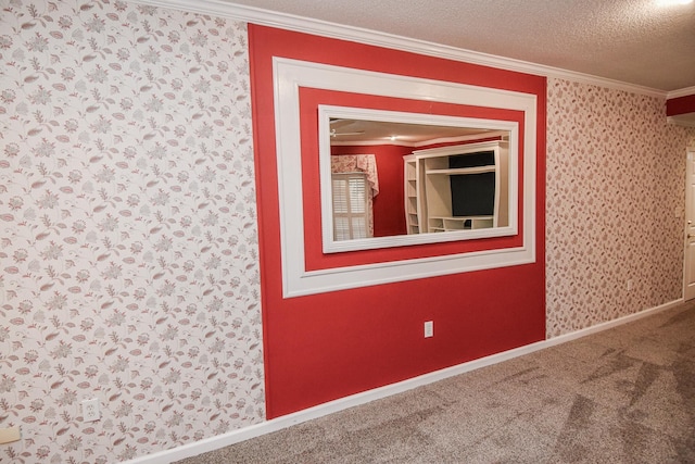 empty room featuring carpet flooring, ornamental molding, and a textured ceiling