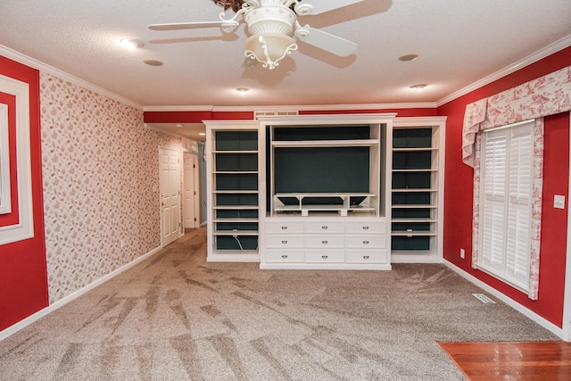 unfurnished bedroom featuring light carpet, ceiling fan, a textured ceiling, and crown molding