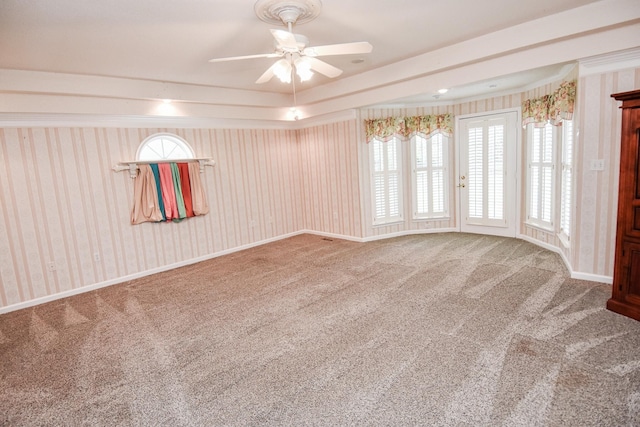 carpeted spare room featuring ceiling fan