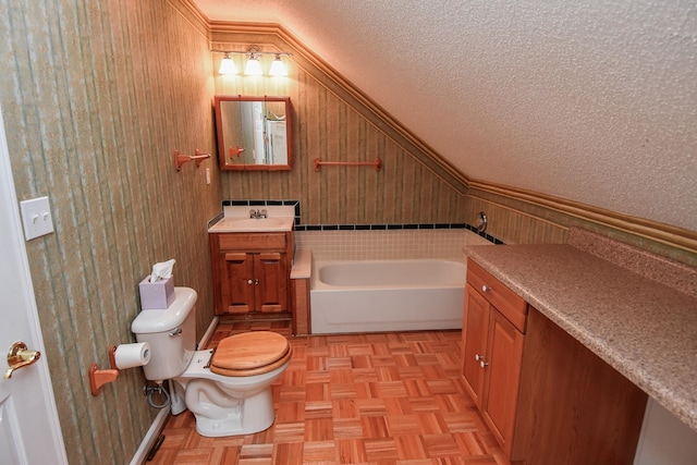 bathroom featuring vanity, a textured ceiling, parquet floors, and a bath to relax in