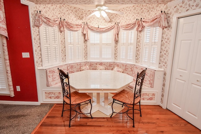 dining room featuring ceiling fan, crown molding, and hardwood / wood-style floors