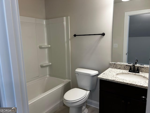 full bathroom with baseboards, vanity, toilet, and shower / bathtub combination