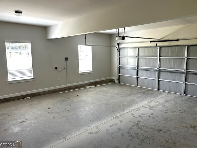 garage with baseboards and a garage door opener