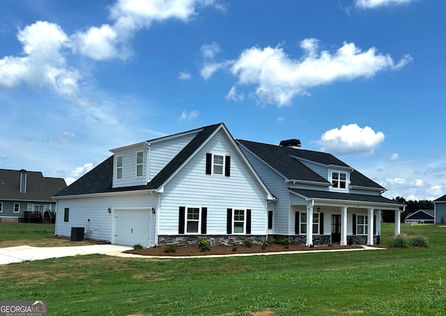 view of front facade with a porch, central AC, stone siding, driveway, and a front lawn