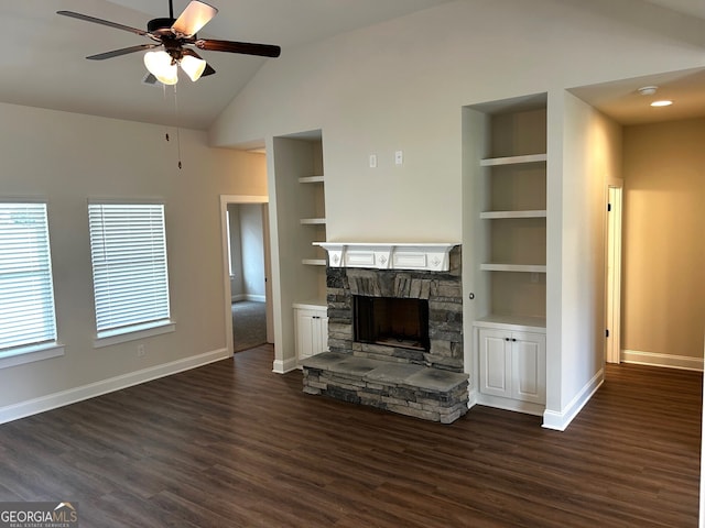 unfurnished living room with lofted ceiling, built in shelves, baseboards, and a fireplace