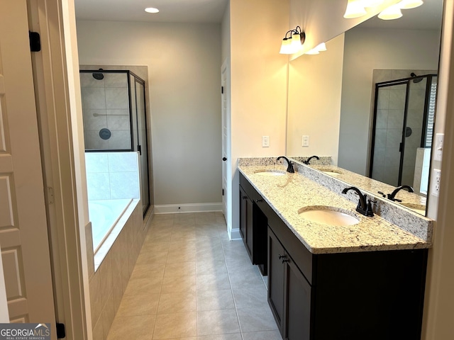 bathroom featuring a sink, a shower stall, and tile patterned floors