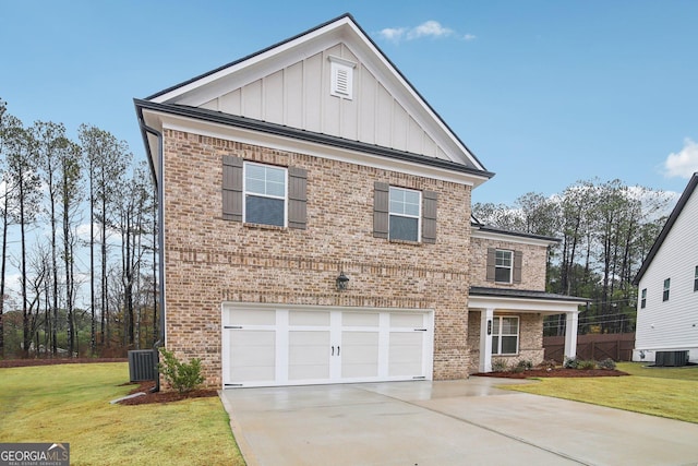 view of front of house featuring a front lawn, a garage, and cooling unit