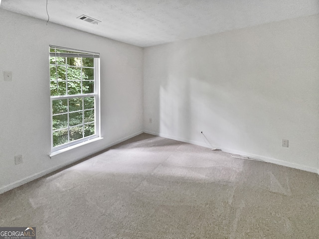 carpeted spare room featuring a textured ceiling