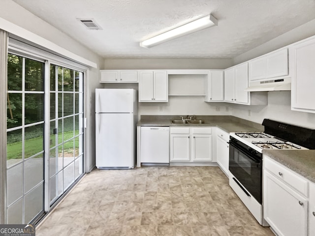 kitchen featuring a textured ceiling, sink, white appliances, and white cabinetry