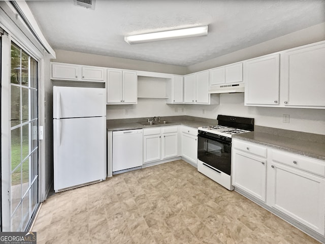 kitchen featuring white cabinetry, white appliances, a wealth of natural light, and sink