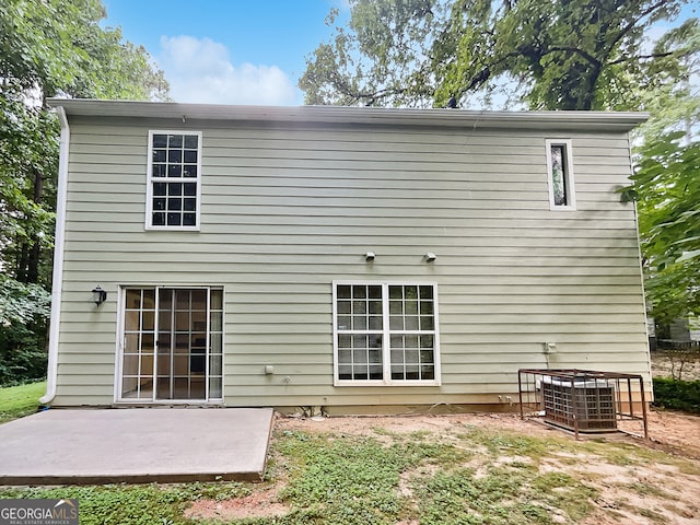 back of house with a patio area and central AC